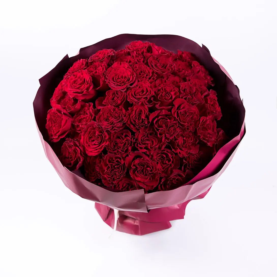 A bouquet of four dozen delicate red roses